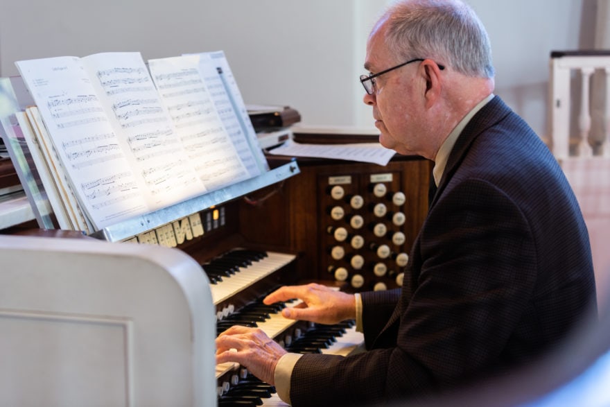 The organist plays the organ during worship
