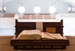 An open Bible sits on the pulpit. The words, "Sir, we would see Jesus" are inscribed below the Bible.