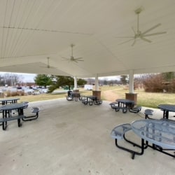 Airy pavilion with round picnic tables